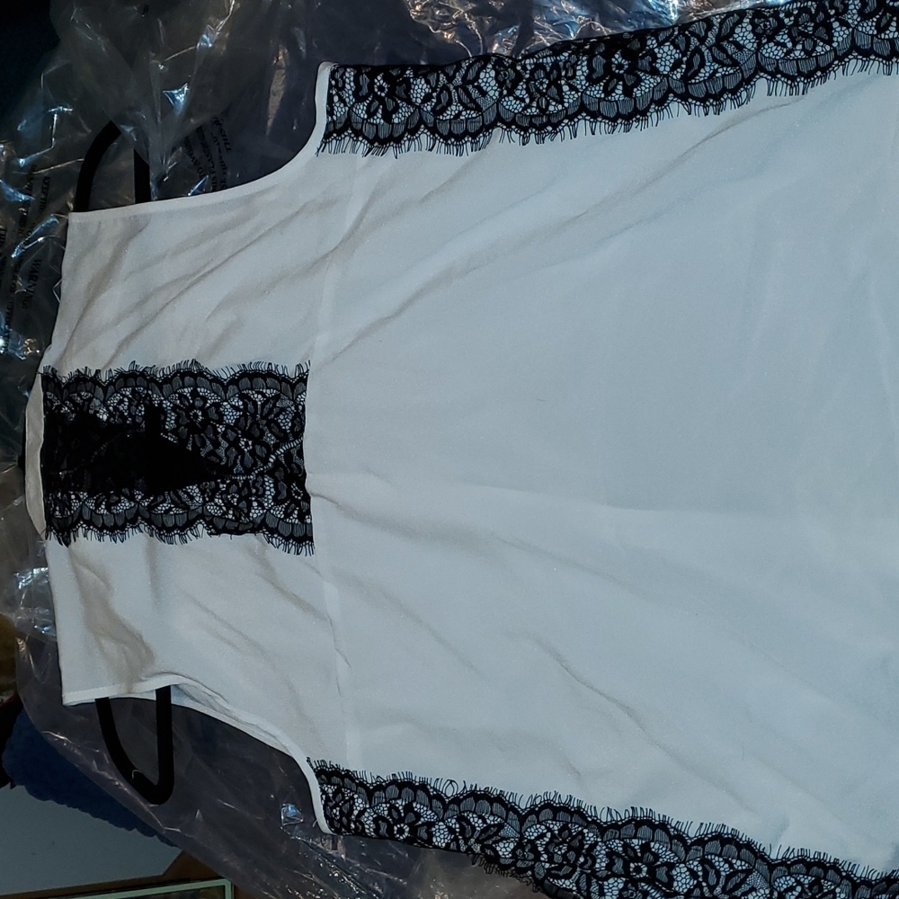 Beautiful white sleeveless blouse with black lace.